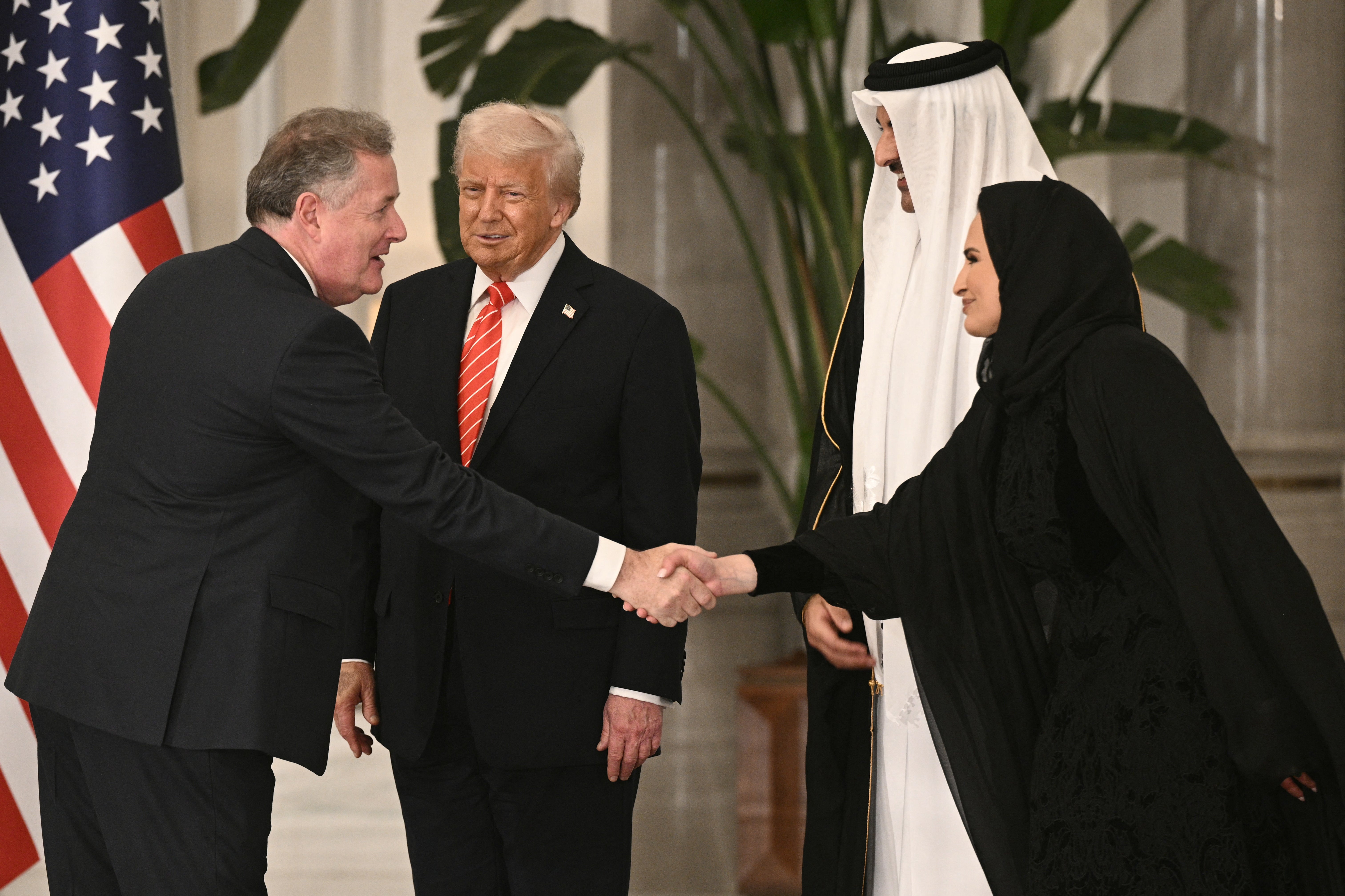 Piers Morgan greets US President Donald Trump, Qatar's Emir Sheikh Tamim bin Hamad al-Thani and his spouse Sheikha Jawaher ahead of a state dinner at the Lusail Palace in Doha in May