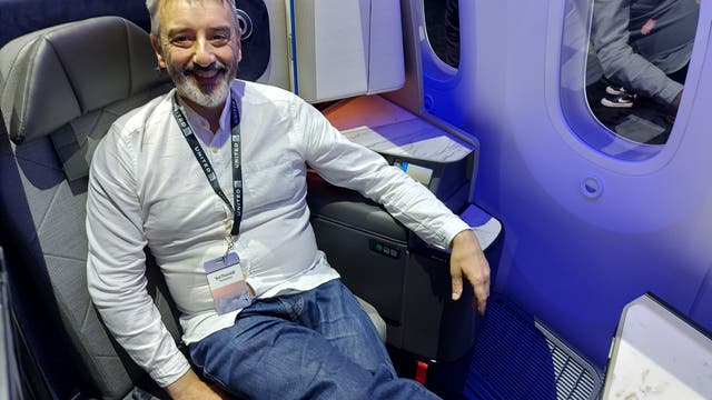 <p>The Independent's Ted Thornhill tries out United Airlines' new Dreamliner seats at a launch event in Brooklyn. He's pictured above in a working version of the new Polaris Studio business-class seat
</p>
