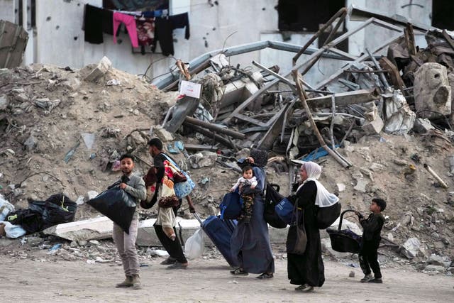 <p>Palestinians evacuate after the Israeli army issued a warning for several schools and a hospital in Gaza City's Rimal neighbourhood on Wednesday</p>