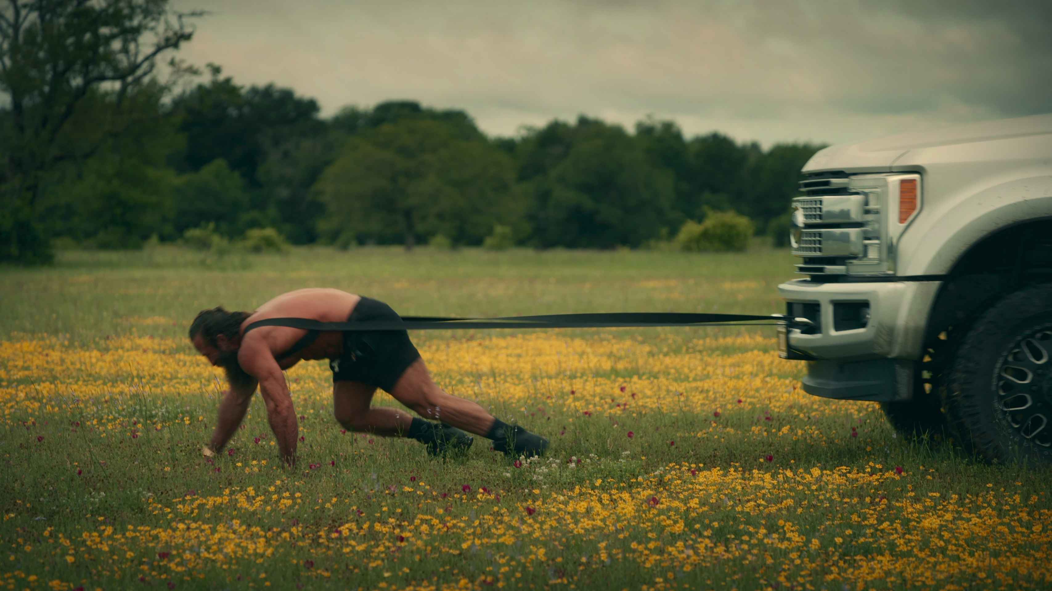 A typical Liver King stunt sees him dragging a 4x4