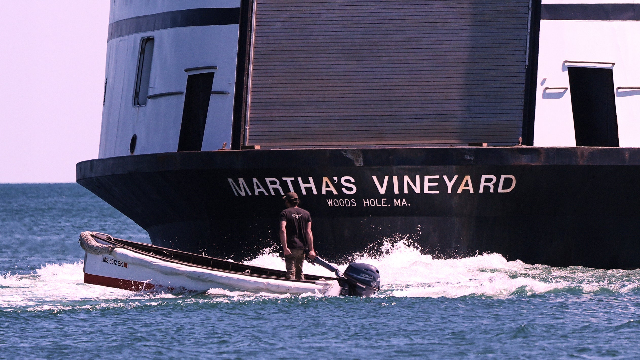 A man navigates the wake behind the Martha's Vineyard Ferry, Monday, May 12, 2025, in Vineyard Haven, Mass. (AP Photo/Charles Krupa)