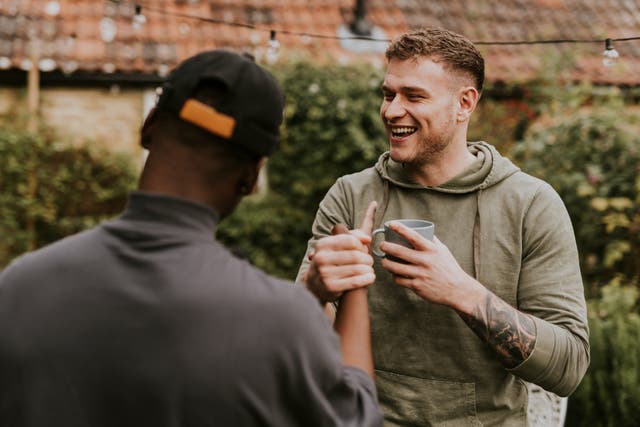 <p>Happy friends talking to one another at a party</p>