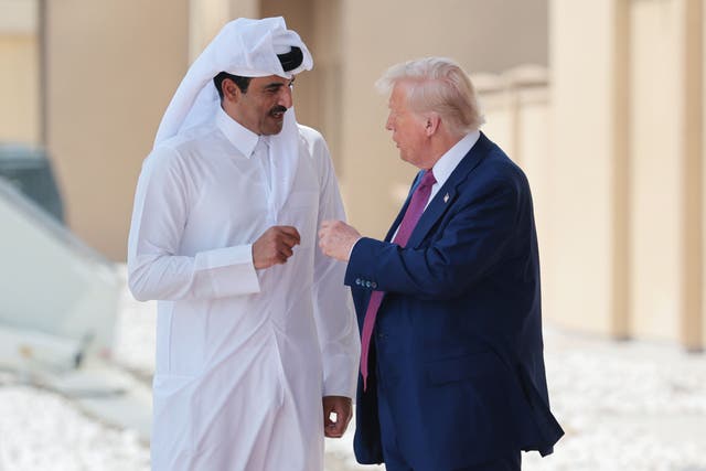 <p>U.S. President Donald Trump speaks with the Emir of Qatar, Tamim bin Hamad al Thani, as he departs the Al Udeid Air Base in Doha on May 15 2025</p>