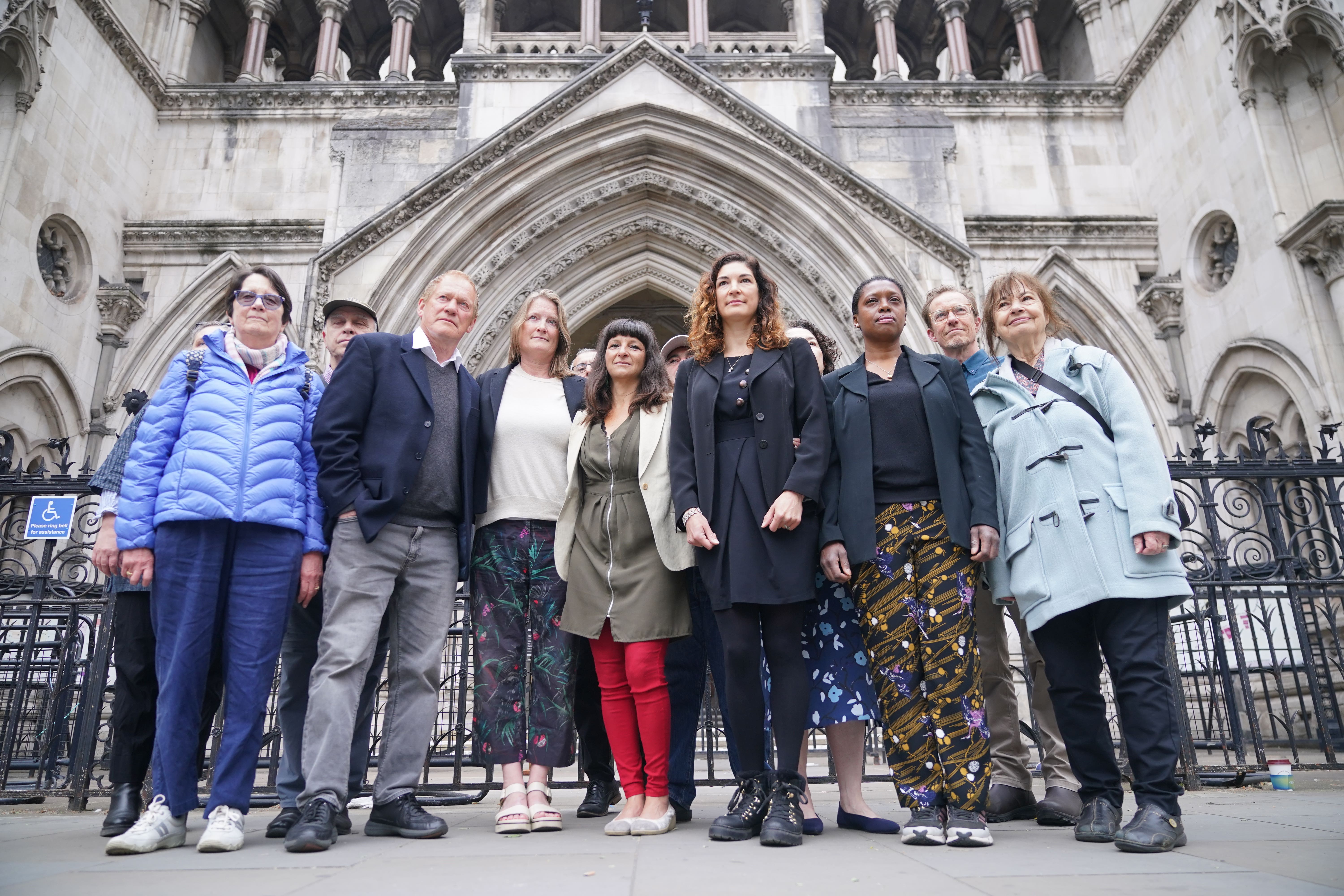 Rebekah Shaman (front centre) from the Protect Brockwell Park Group stands with others residents from Brockwell, south London, outside the Royal Courts of Justice, central London, where she is bringing a legal action against Lambeth Council (Yui Mok/PA)
