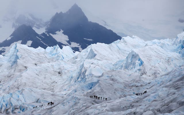 <p>Tourists trek on the Perito Moreno glacier</p>