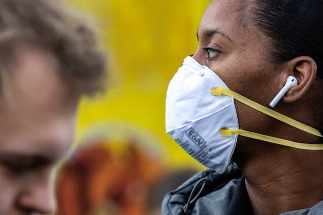 <p>A woman wearing a protective mask is seen in Union Square on March 9, 2020 in New York City</p>
