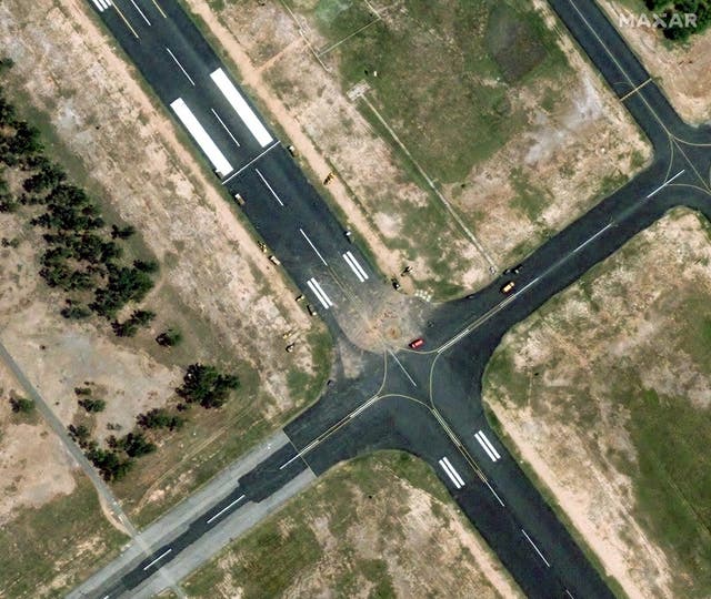<p>A satellite image shows a view of the response crew vehicles at damaged runway of PAF Base Mushaf</p>