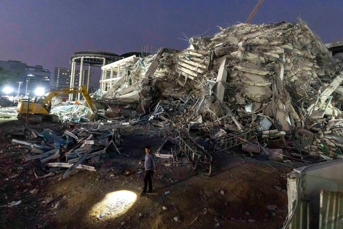 Thai construction magnate and others surrender to police on charges over building collapse in quake