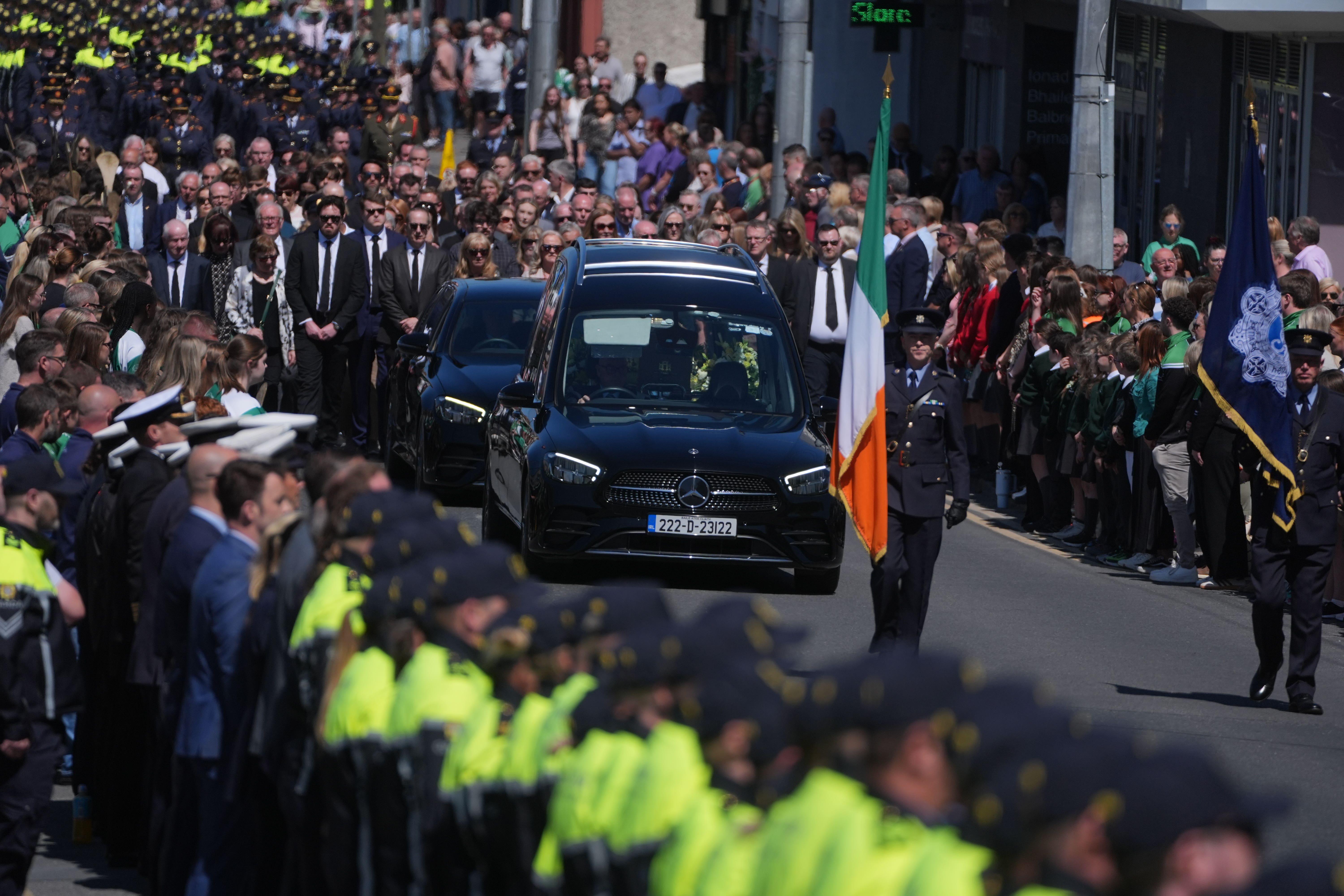 Garda officers line the route as the funeral cortege for Garda Kevin Flatley arrives at St. Peter and Paul’s Church, Balbriggan, Co. Dublin. The officer died when he was struck by a motorcycle at a speed checkpoint in Dublin last weekend. Picture date: Friday May 16, 2025.