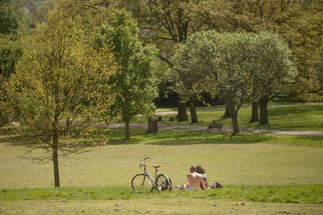 People enjoy the warm weather in Brockwell Park near Herne Hill, London. (PA)