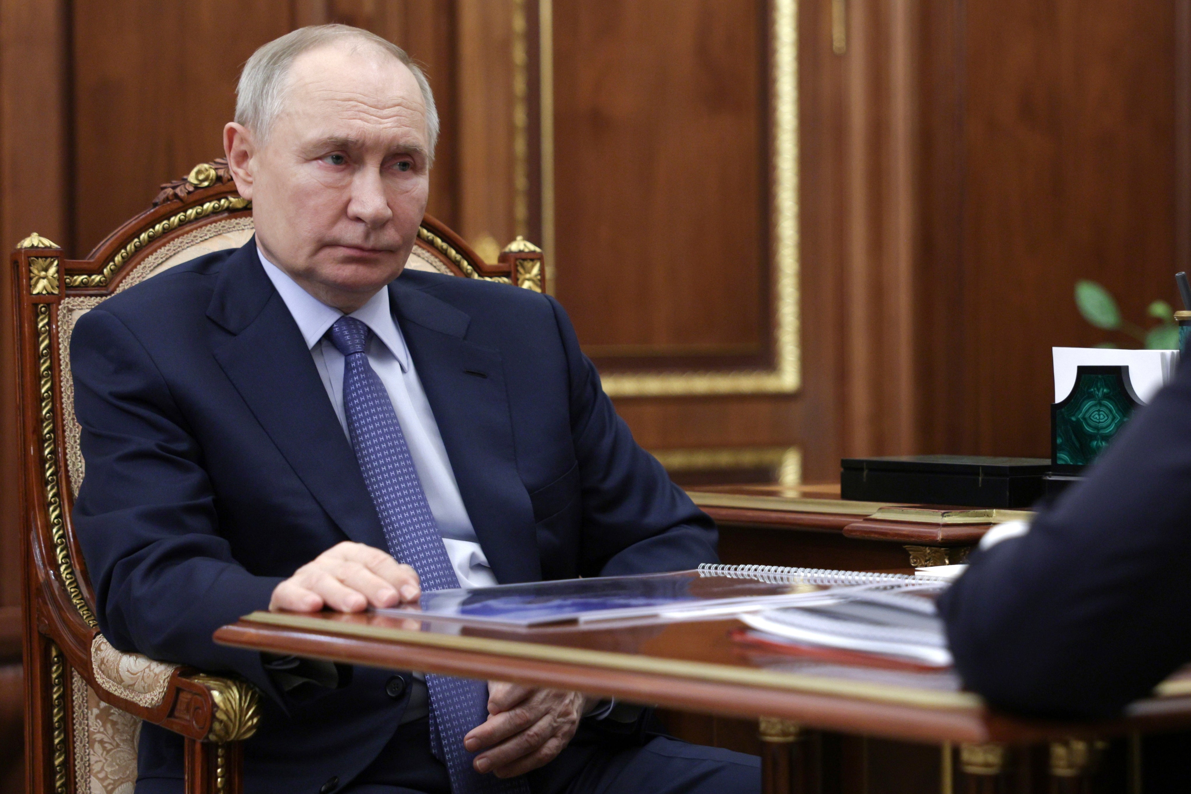 Russian president Vladimir Putin listens to Promsvyazbank chief executive Pyotr Fradkov during their meeting at the Kremlin in Moscow, Russia, on Thursday, 15 May 2025