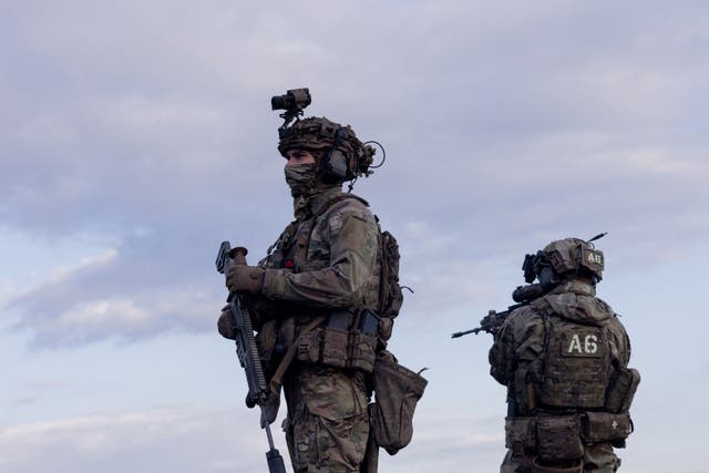 <p>Ukrainian servicemen stand guard during a military training at an undisclosed location in Kharkiv Region on 14 May 2025</p>
