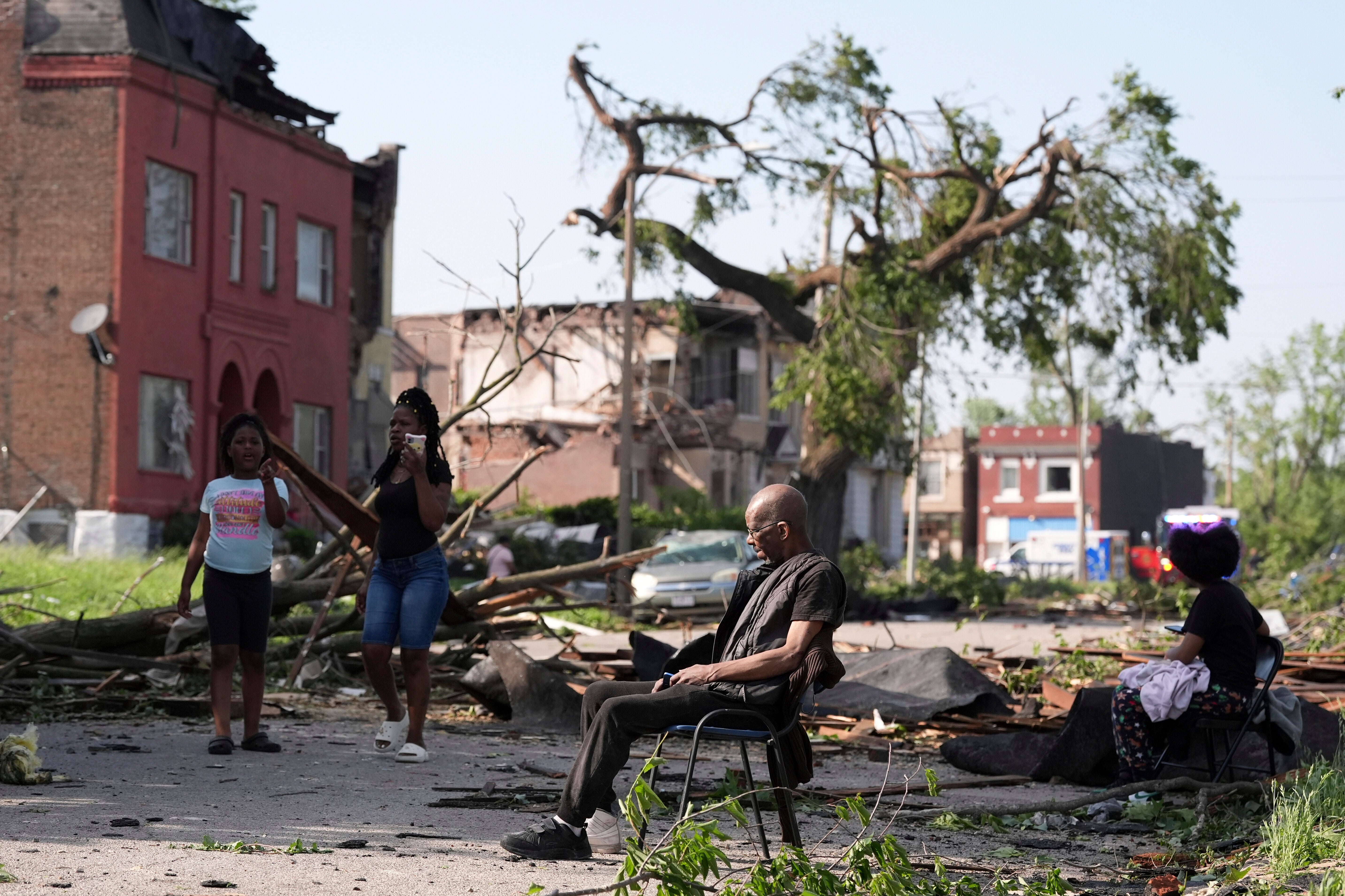A man sits in a chair after a severe storm moved through St. Louis, Missouri
