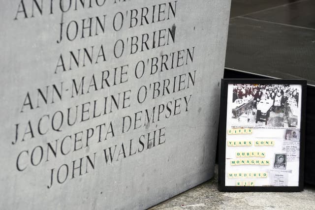 A framed picture sits beside the memorial to the victims of the Dublin and Monaghan bombings (Brian Lawless/PA)