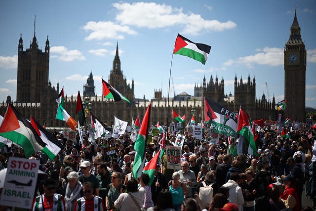 <p>Pro-Palestinian supporters pass the Houses of Parliament as they take part in a march through central London</p>