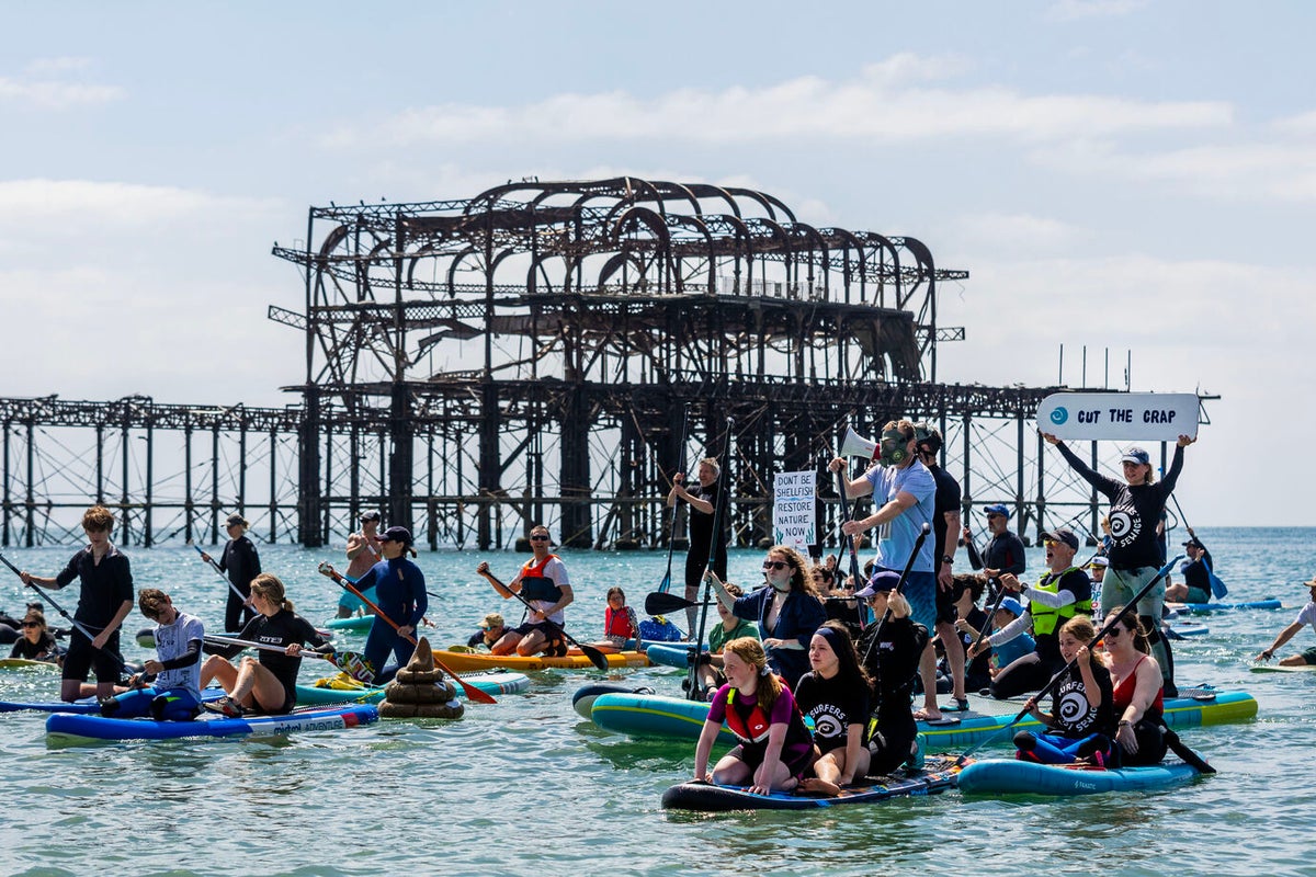 Thousands turn out for paddle out protests over sewage scandal'