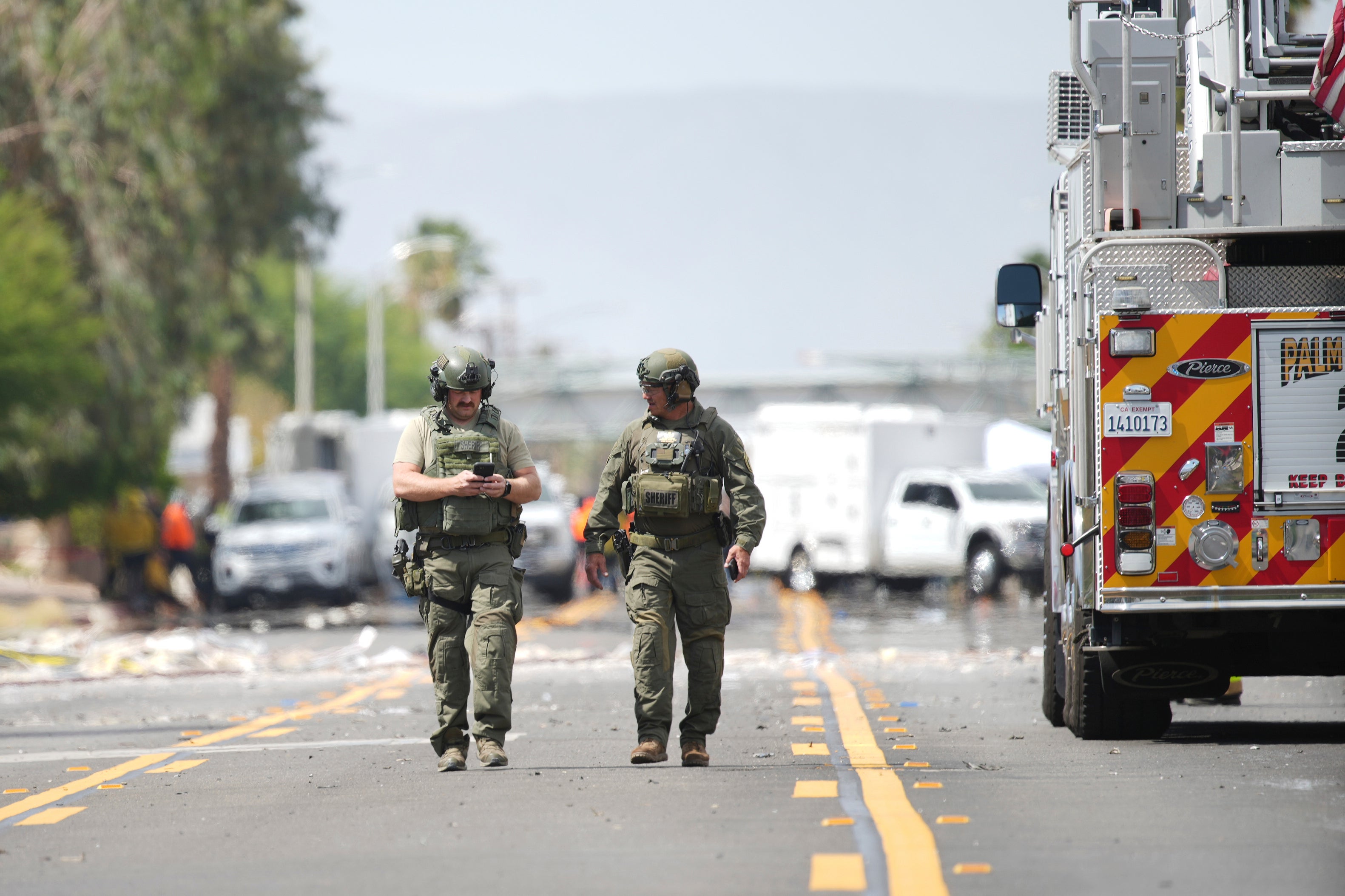 Sheriffs’ deputies walk near the scene of the explosion. Bartkus was killed in the blast that left four others hurt.