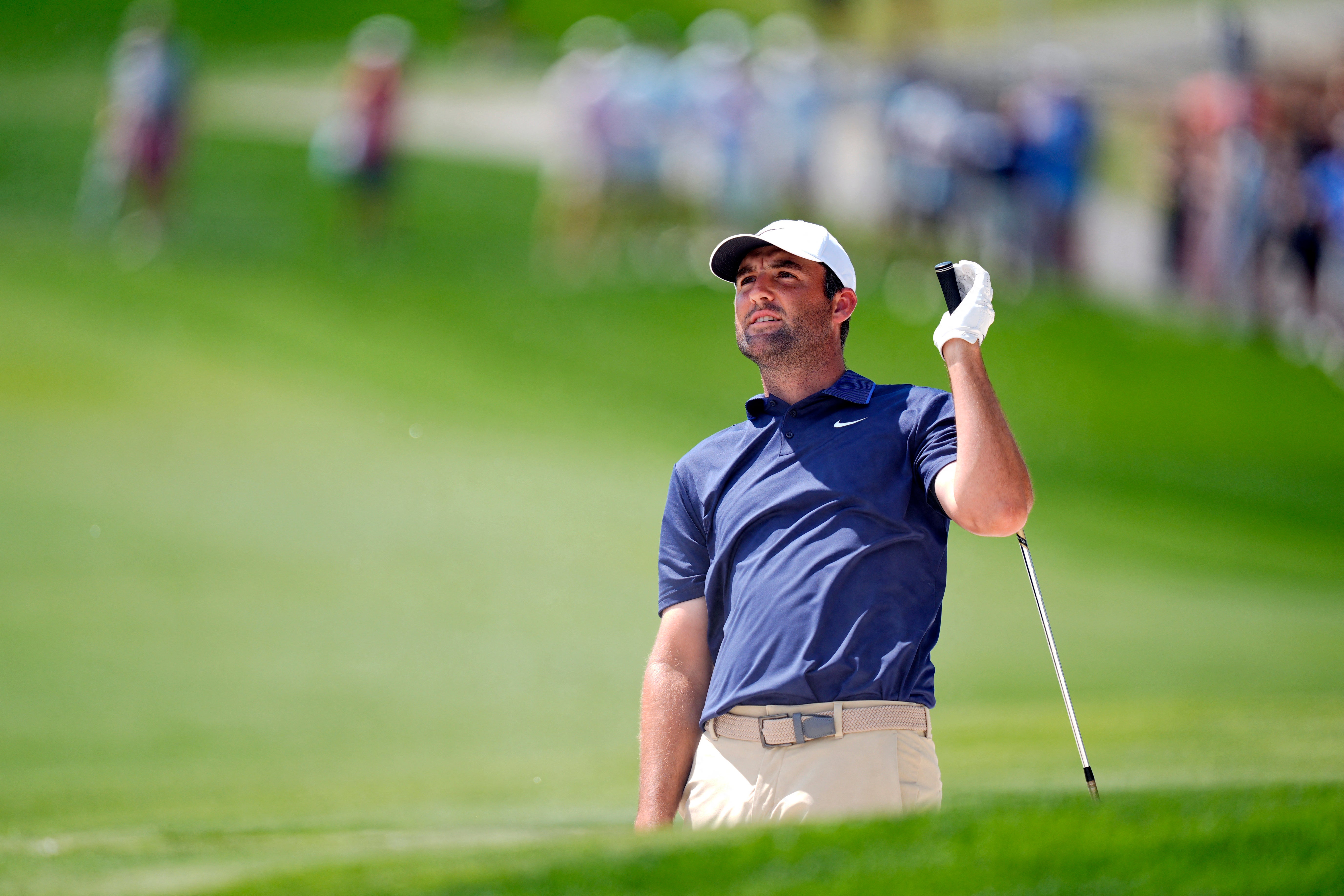 Scheffler hits from the fairway bunker on five