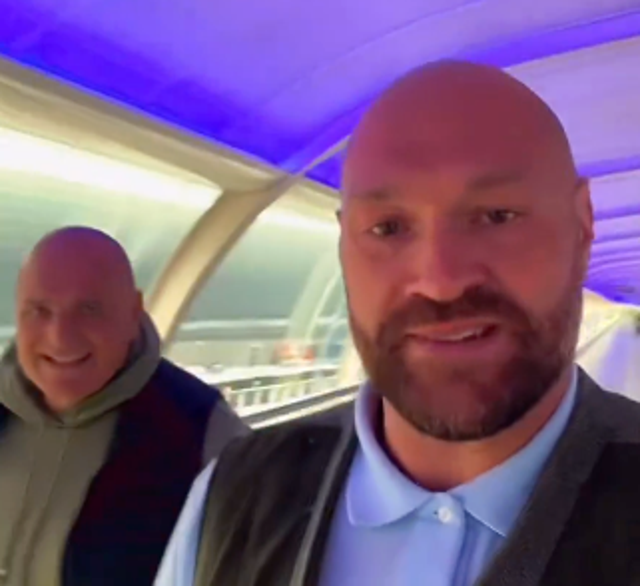 <p>Tyson Fury on the move with his father John</p>