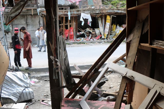 <p>File. People inspect a market that was damaged in cross-border shelling before the India-Pakistan ceasefire came into effect, in Jura village, Neelum Valley</p>
