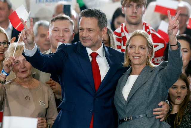 <p>Karol Nawrocki, backed by Poland's right-wing Law and Justice (PiS) party, waves to supporters with his wife in Gdansk after a better-than-expected result in first-round voting</p>