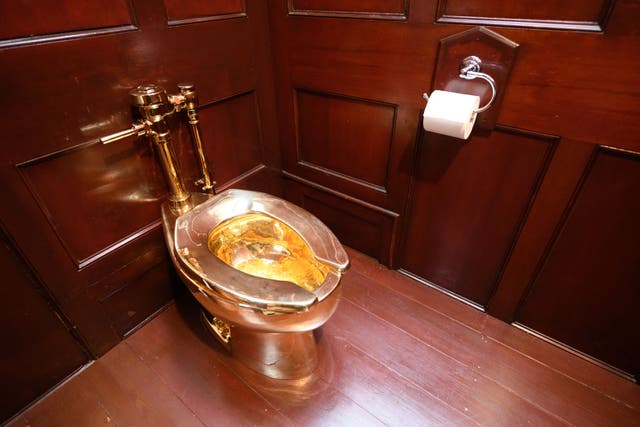 <p>A fully-working solid gold toilet, created by artist Maurizio Cattelan, is seen at Blenheim Palace on 12 September 2019</p>