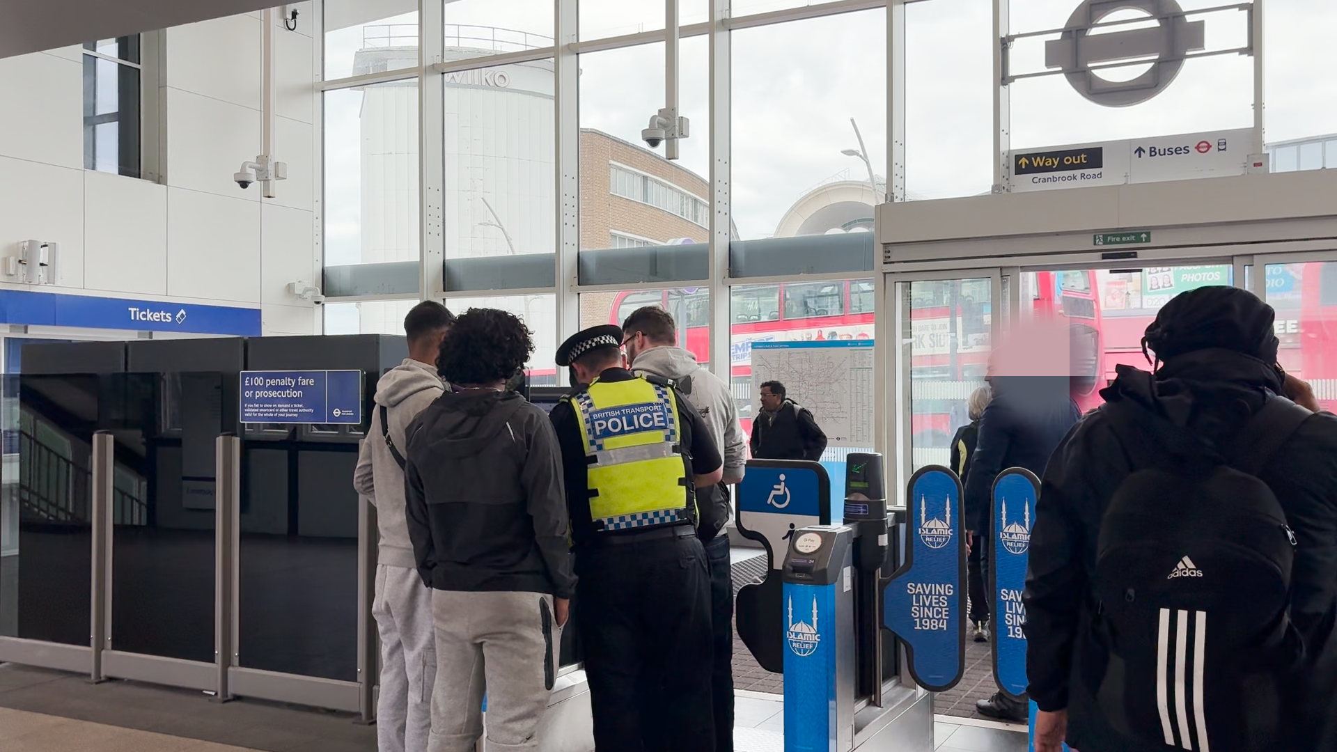 British Transport police pictured questioning passengers on their operation to stop fare dodgers in Ilford