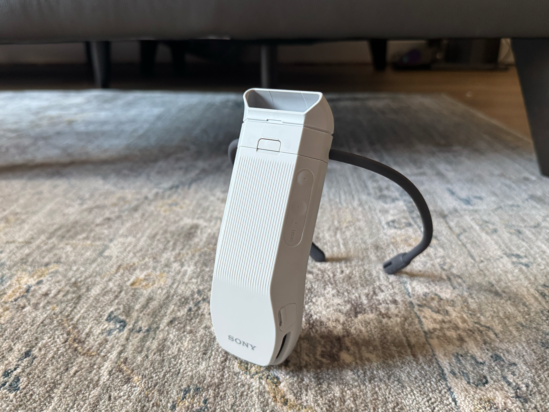 It has a malleable neck band that can be adjusted, with full controls on the device itself