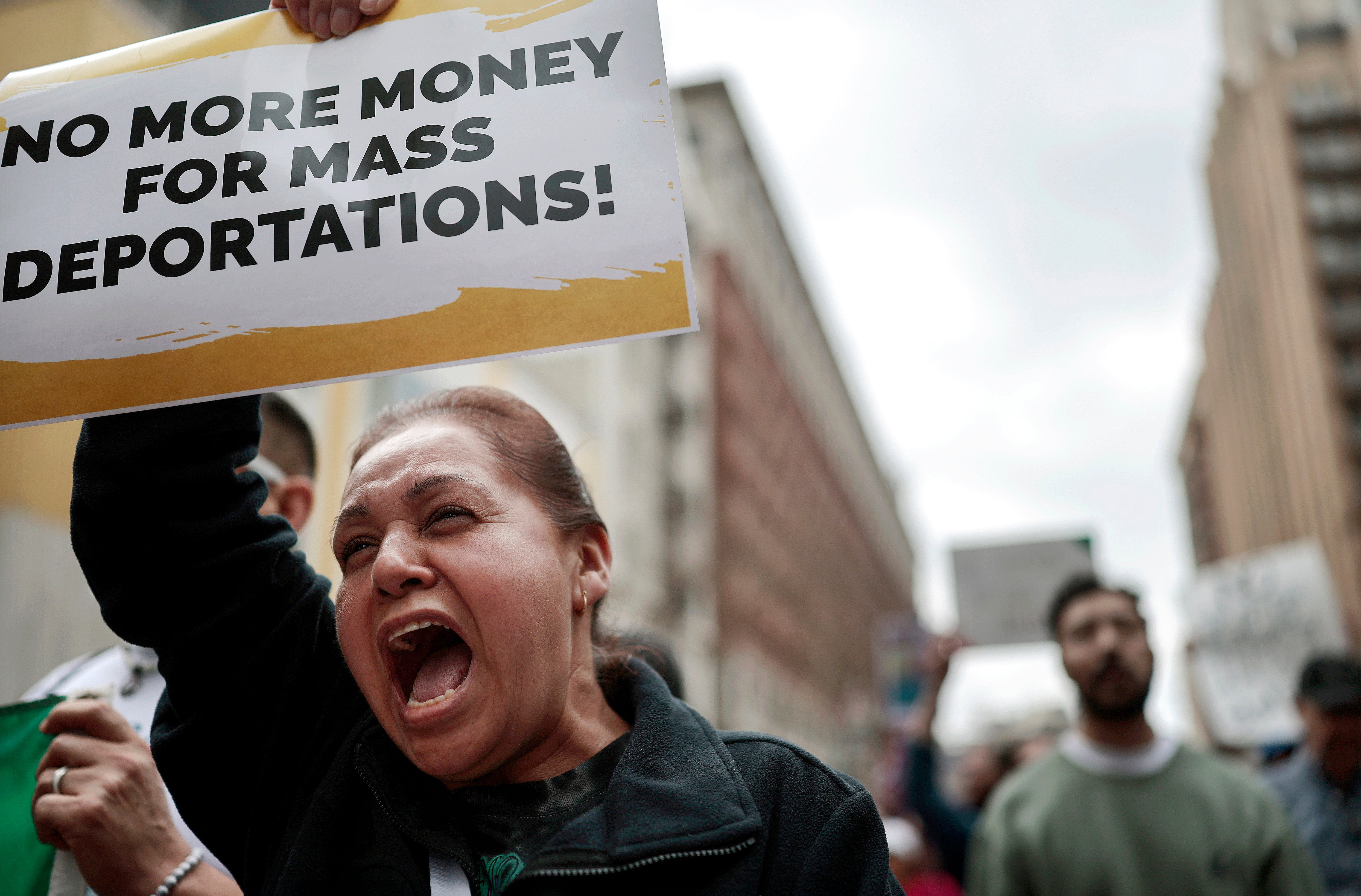 A demonstrator carries a sign reading ‘No More Money For Mass Deportations’ in Los Angeles. House Republicans are proposing more than $150 in new spending to support Tump’s expansion of immigration enforcement