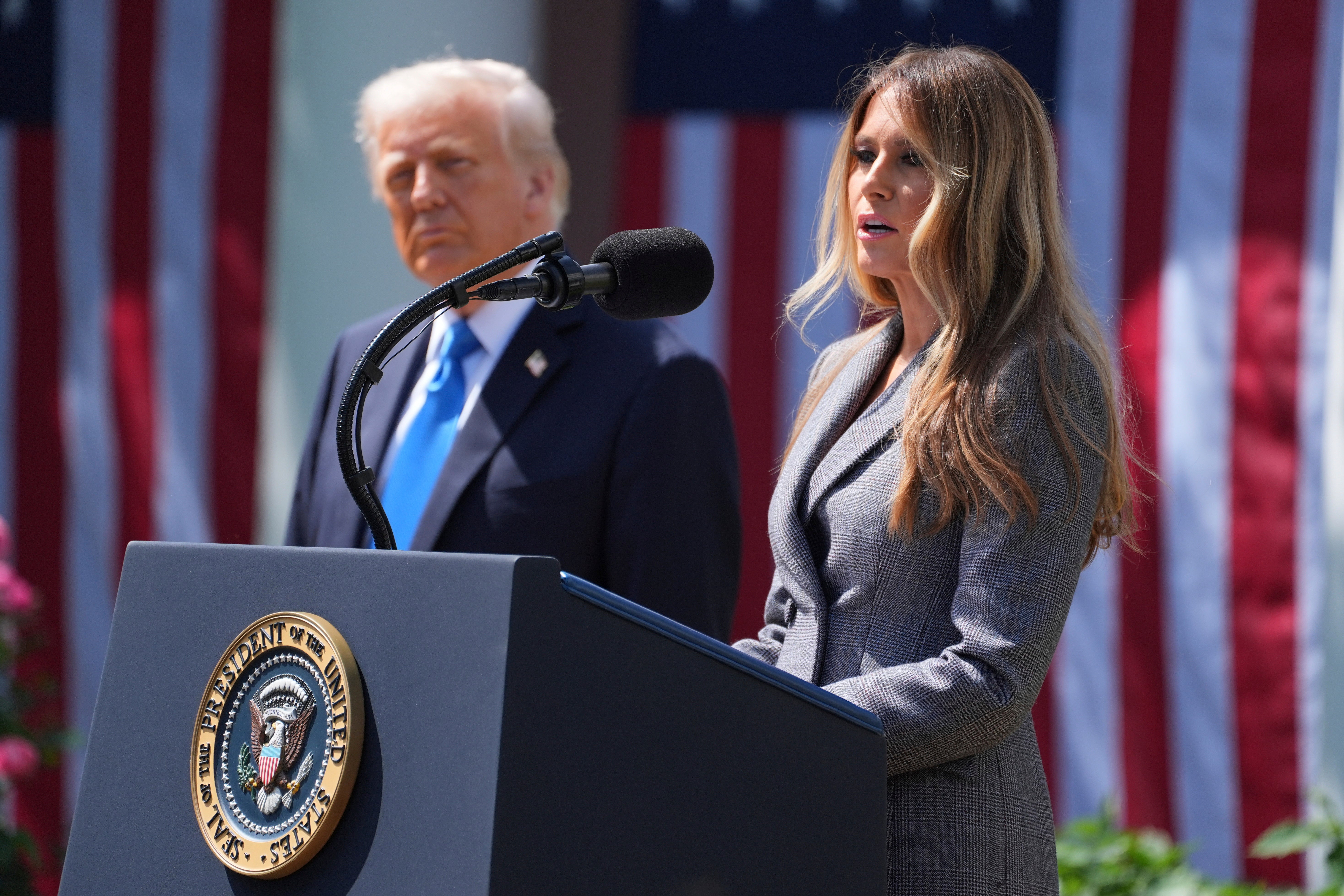 First lady Melania Trump speaks President Donald Trump listens during a bill signing event for the ‘Take it Down Act’ in the Rose Garden of the White House.