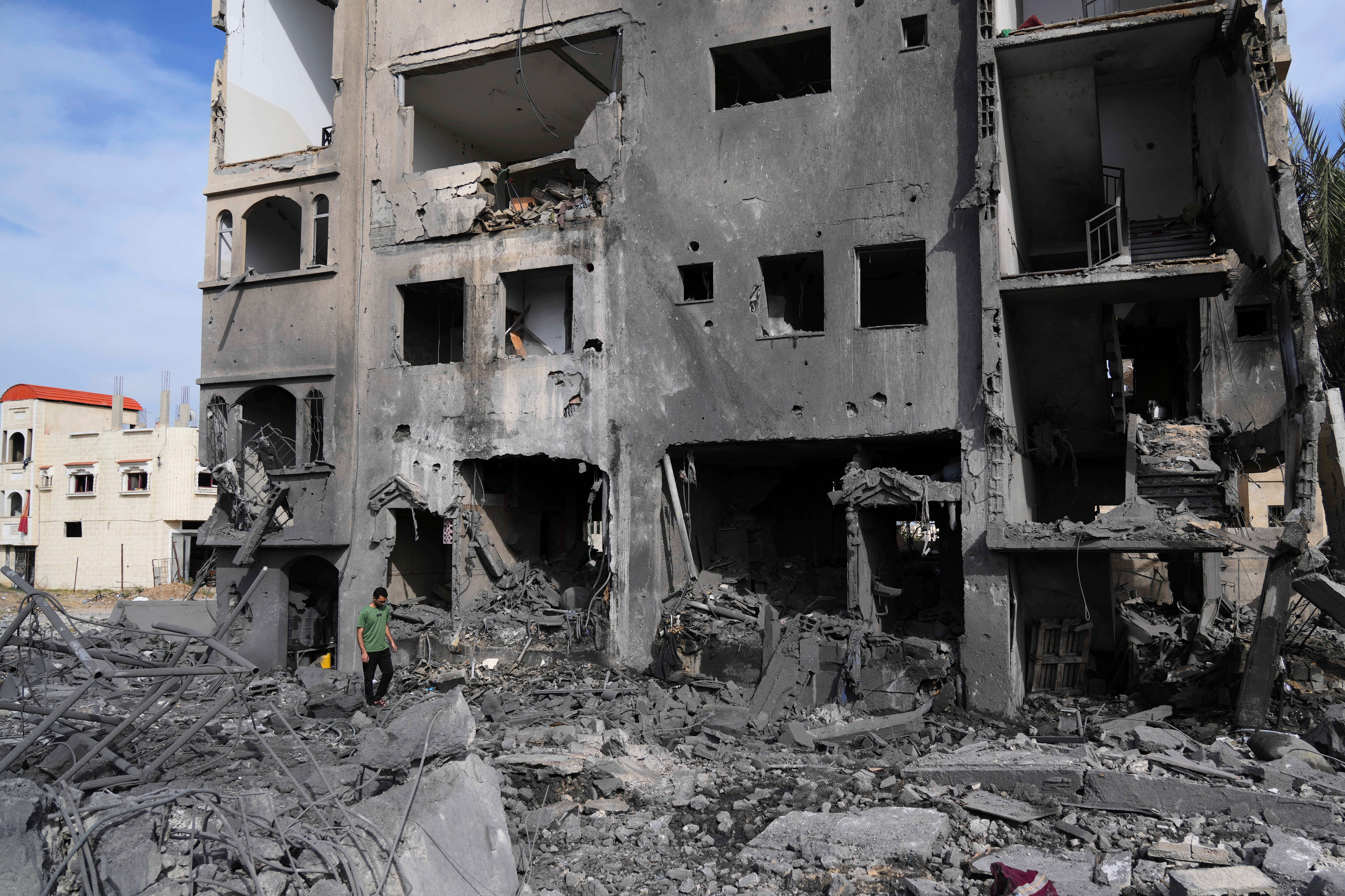 A Palestinian man walks on the rubble of the Al-Zainati family's home, destroyed by Israeli airstrikes in Khan Younis on May 15, 2025