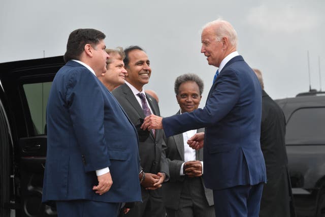 <p>US President Joe Biden greets Chicago Mayor Lori Lightfoot (2nd-R), Illinois Governor J.B. Pritzker (L), Rep. Mike Quigley (2n-L) and Rep. Raja Krishnamoorthi (3rd-L) as he disembarks from Air Force One upon arrival at O'Hare International Airport in Chicago, Illinois, October 7, 2021,  to promote the importance of Covid-19 vaccine requirements</p>