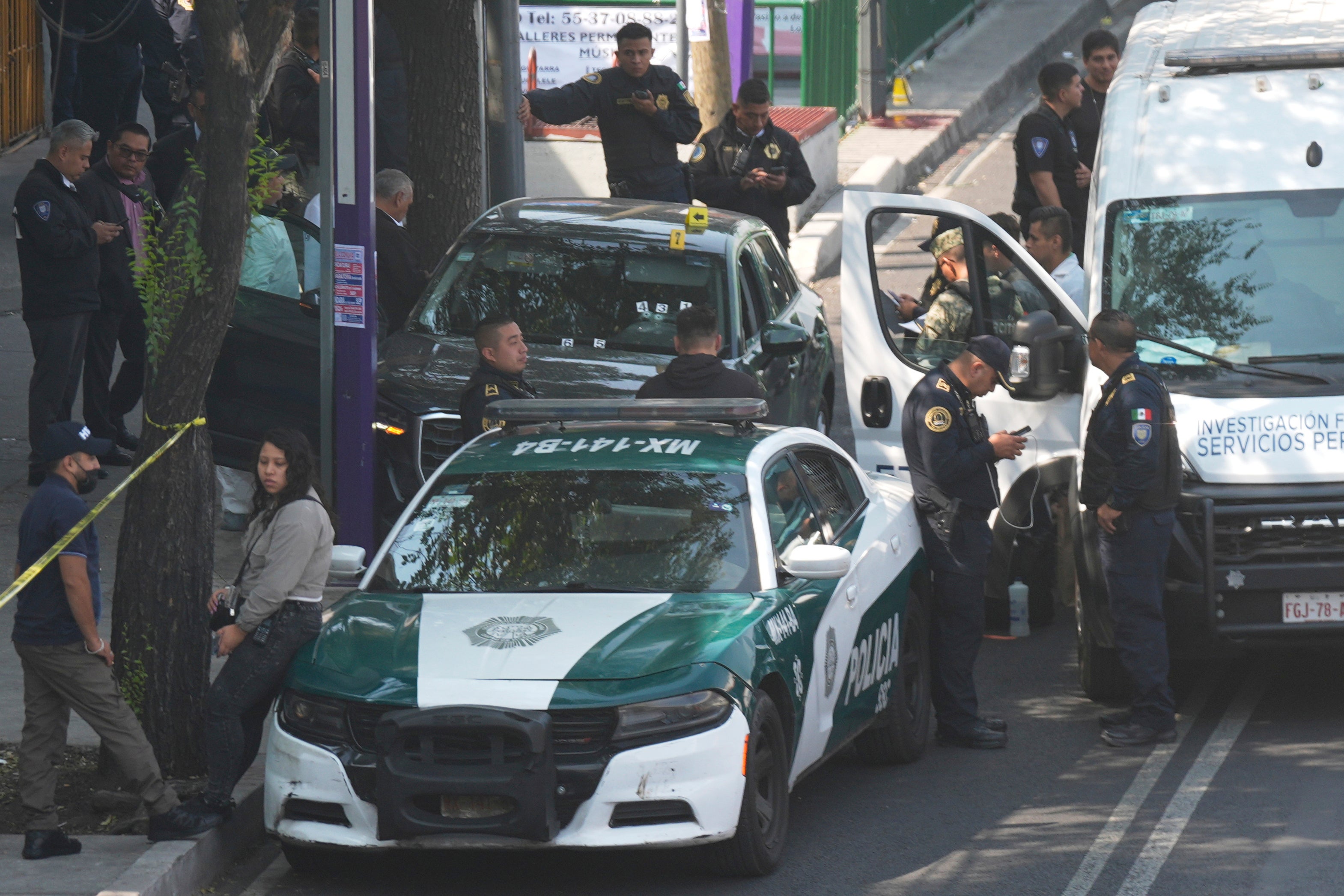 Police inspect the car where Mexico City Mayor Clara Brugada's private secretary, Ximena Guzman, and adviser, Jose Munoz, were killed in Mexico City, Tuesday, May 20, 2025. (AP Photo/Fernando Llano)
