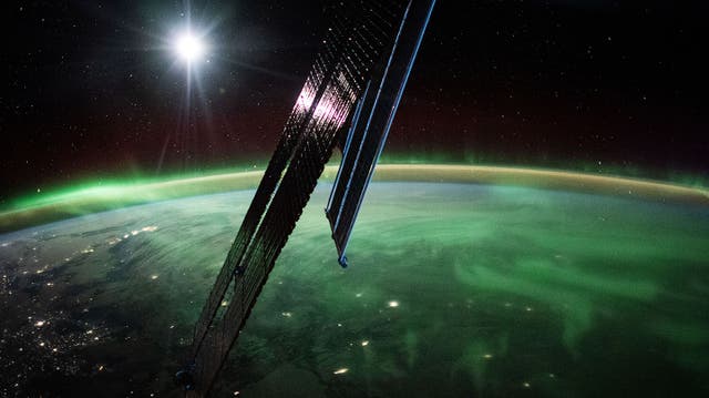 <p>Photo taken from the International Space Station of the aurora borealis streaming above southeastern Manitoba</p>