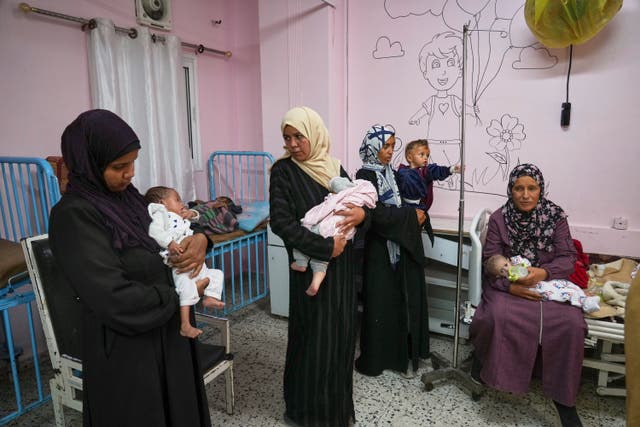<p>Palestinian women care for their babies at the malnutrition clinic in Nasser hospital, Khan Younis, Gaza Strip on May 1</p>