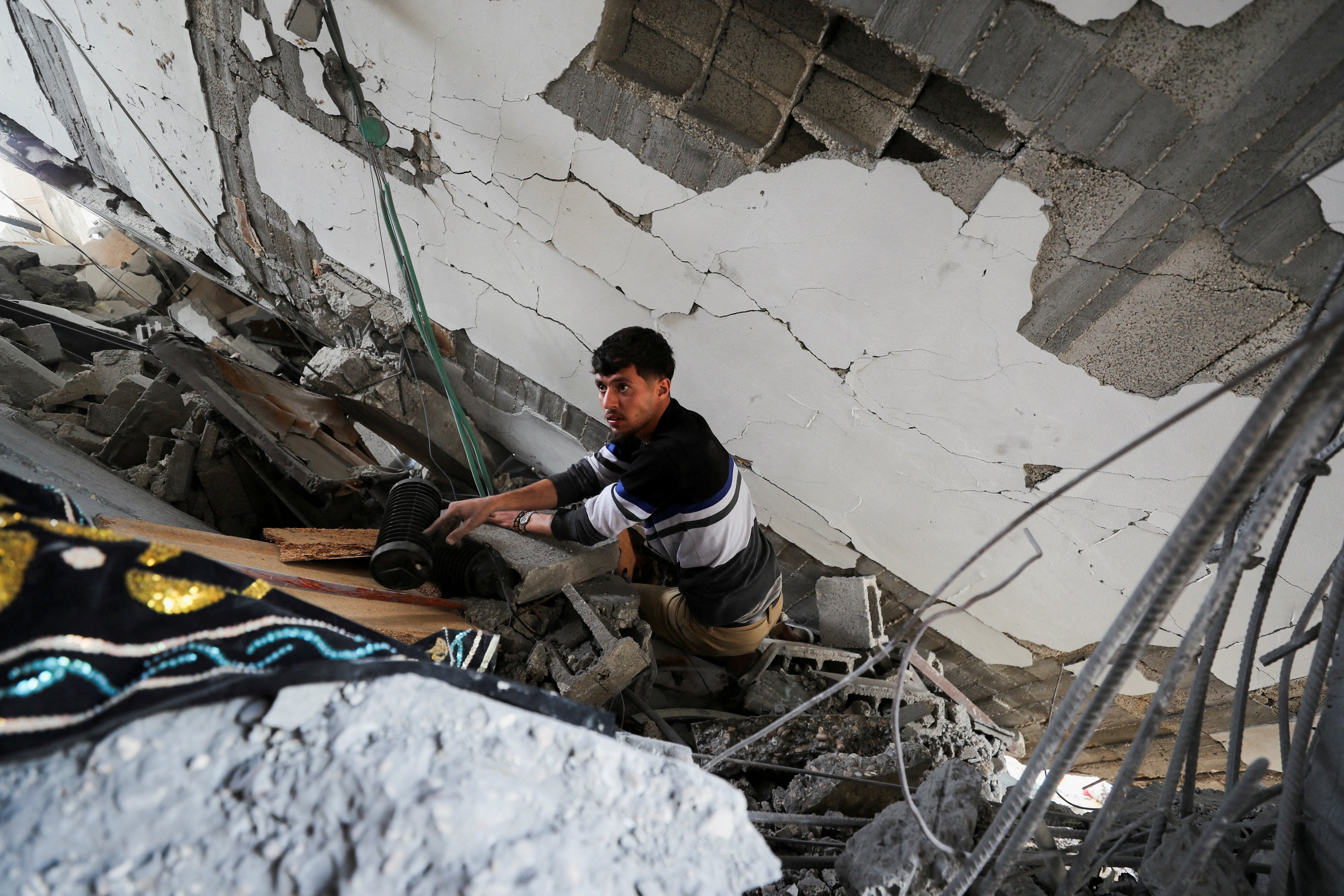 A Palestinian man inspects the site of an Israeli strike on a house, in Jabalia, northern Gaza Strip on Wednesday
