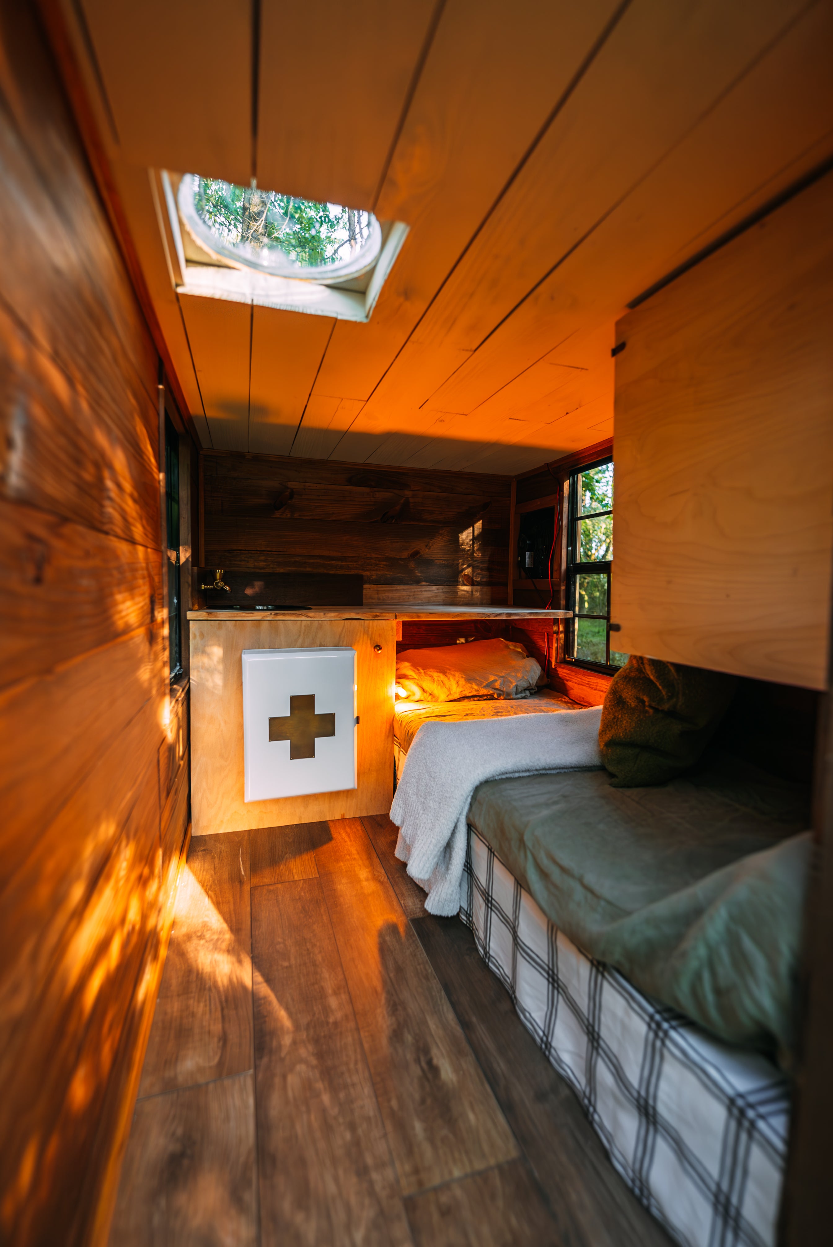 The features include a shower, toilet, bed, sink, running water and solar power