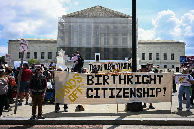 <p>People hold banners and signs as they participate in a protest outside the US Supreme Court over President Donald Trump's move to end birthright citizenship as the court hears arguments over the order in Washington, DC, on May 15.</p>