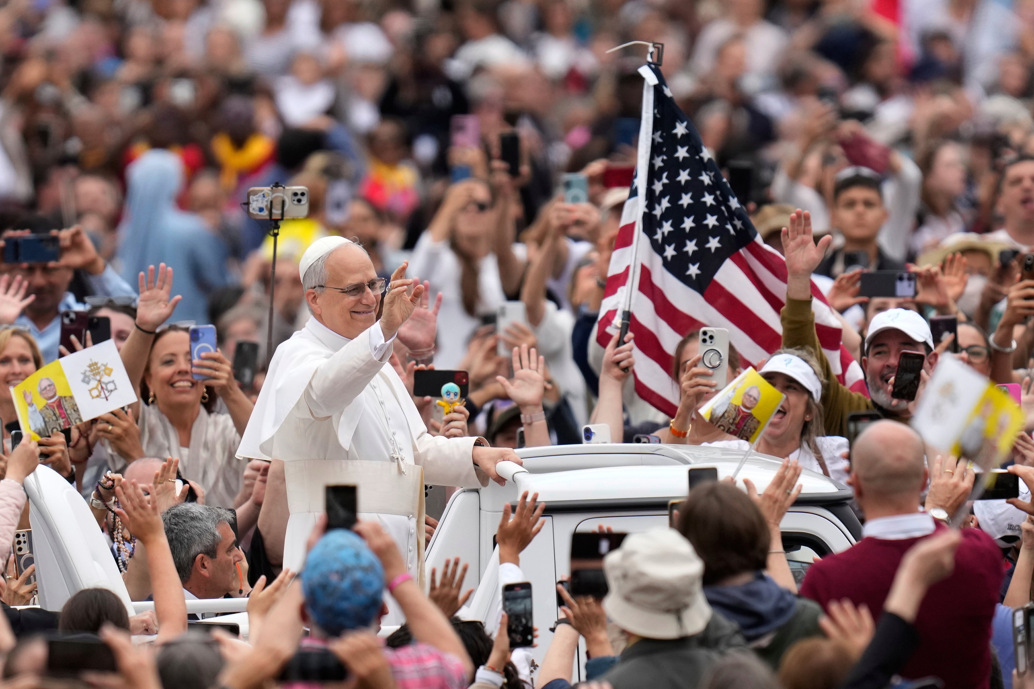 Pope Leo XIV waves as he arrives for his first weekly general audience in St Peter’s Square