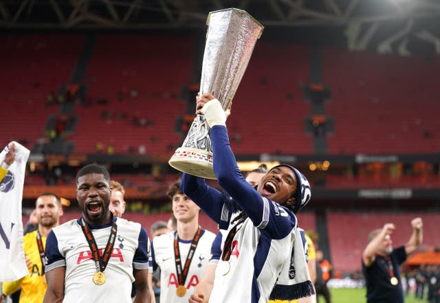 <p>Tottenham Hotspur’s Djed Spence with the trophy following the UEFA Europa League final at the Estadio de San Mames in Bilbao (PA)</p>