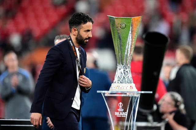 <p>Manchester United manager Ruben Amorim walks past the trophy following defeat</p>