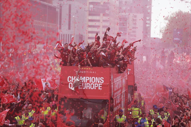 <p>Liverpool's players on board a parade bus after winning the UEFA Champions League, June 2019, Liverpool</p>