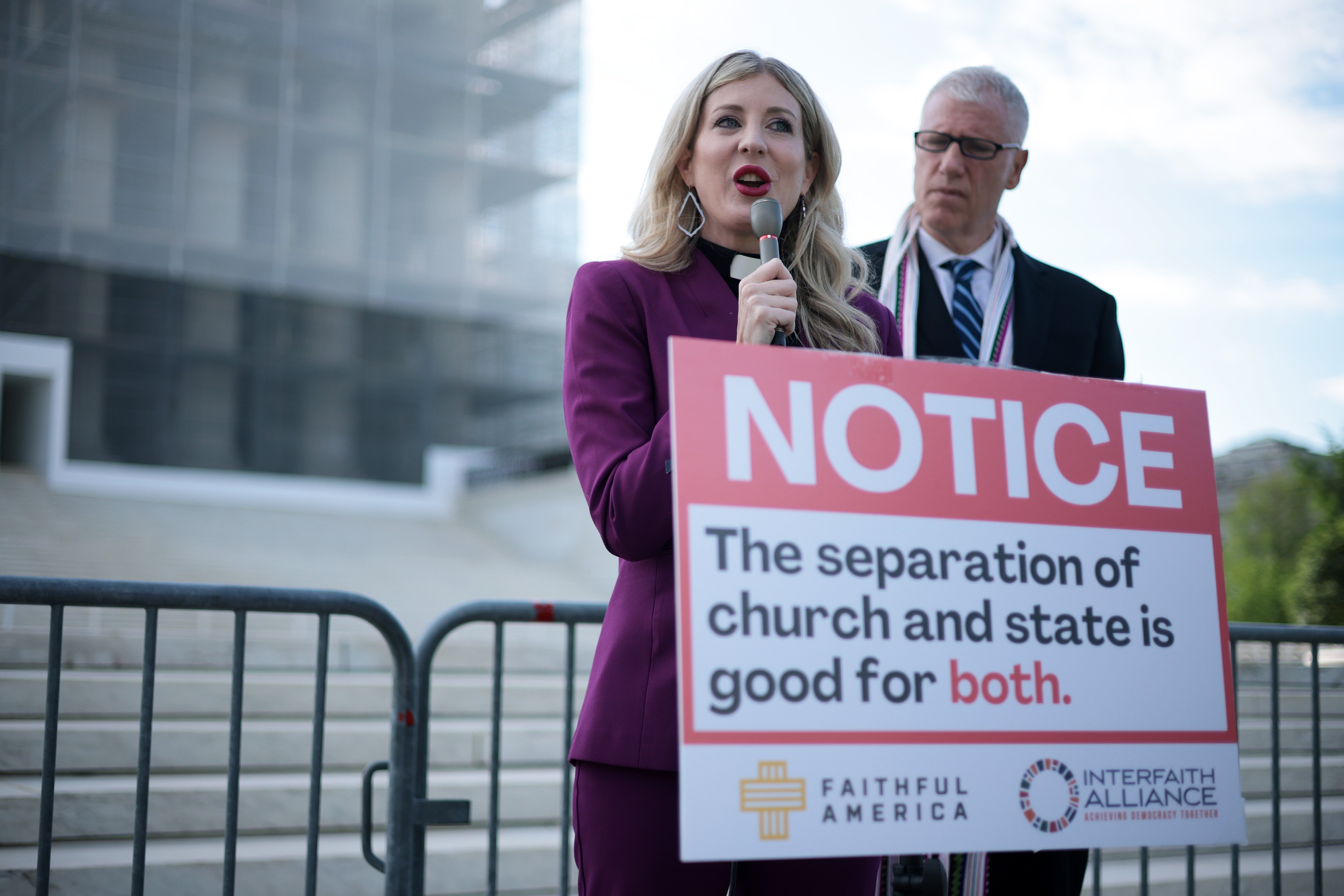 Rev. Shannon Fleck, left, speaks out against Oklahoma’s proposed Catholic public charter school at the steps of the Supreme Court April 30. The justices reached a tie decision its approval May 22