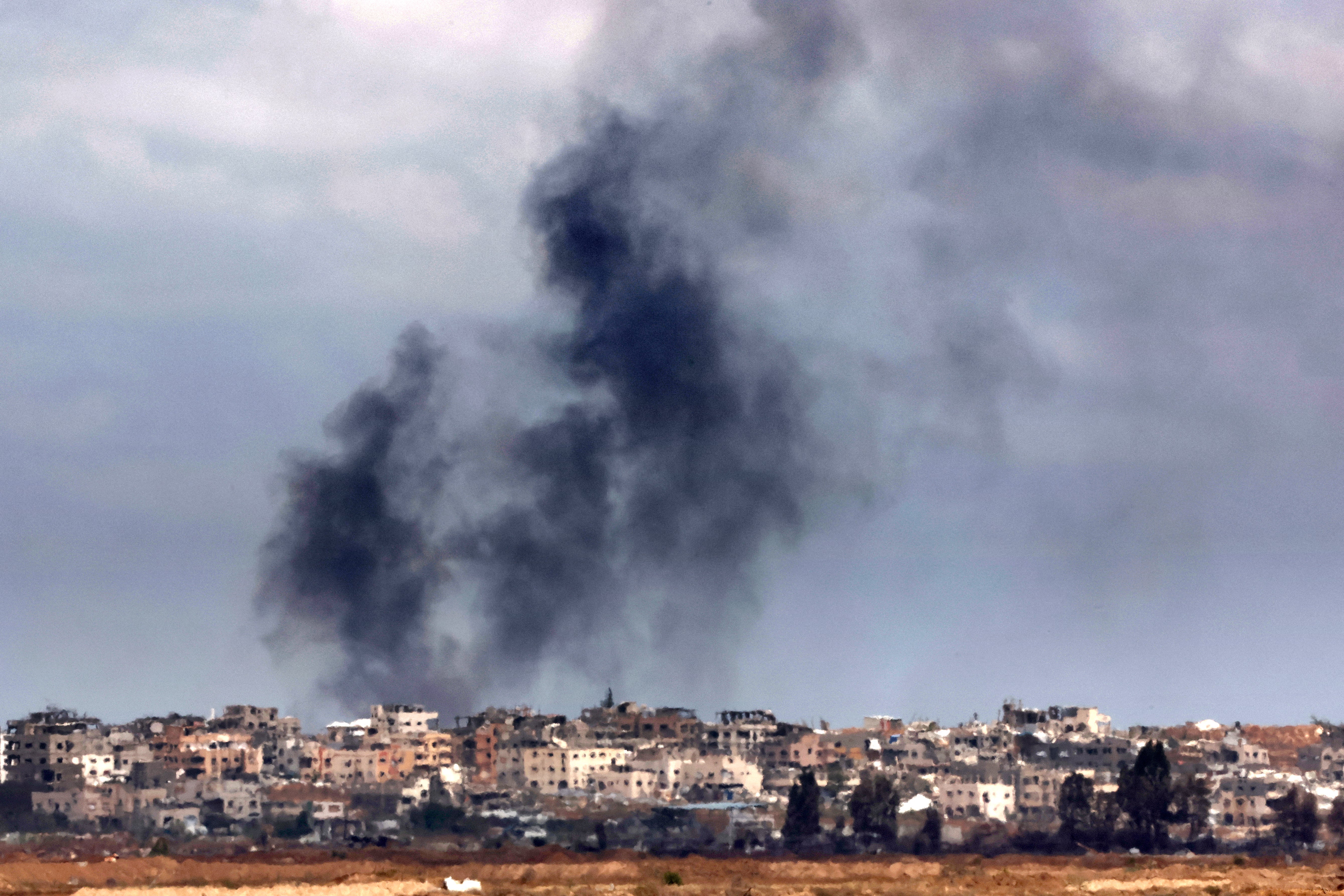 A picture taken from the Israeli side of the border with the Gaza Strip, shows smoke billowing above destroyed buildings during Israeli bombardment in the besieged Palestinian territory on Thursday