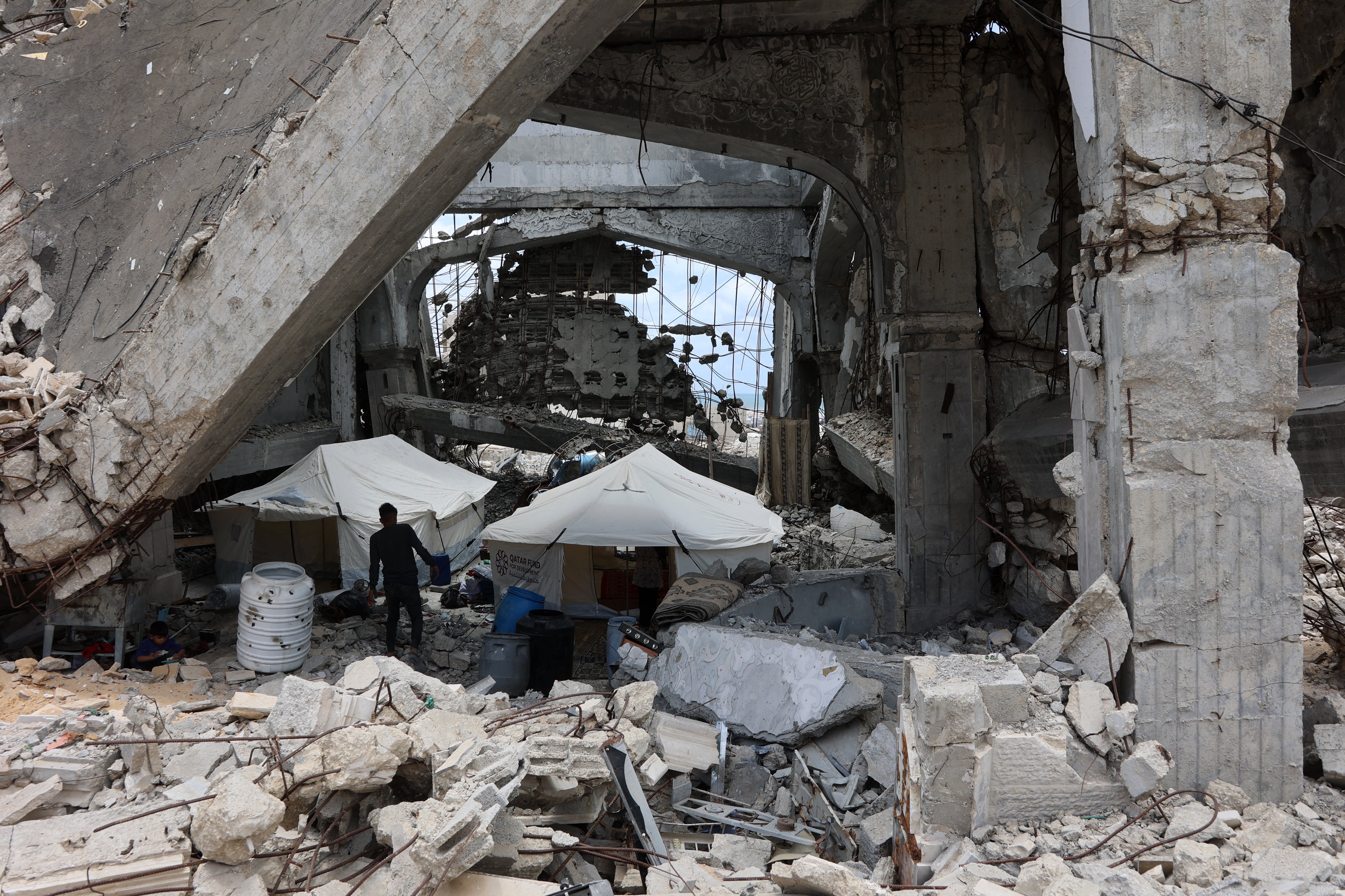 A Palestinian man near tents set up inside a destroyed building near Gaza City's port