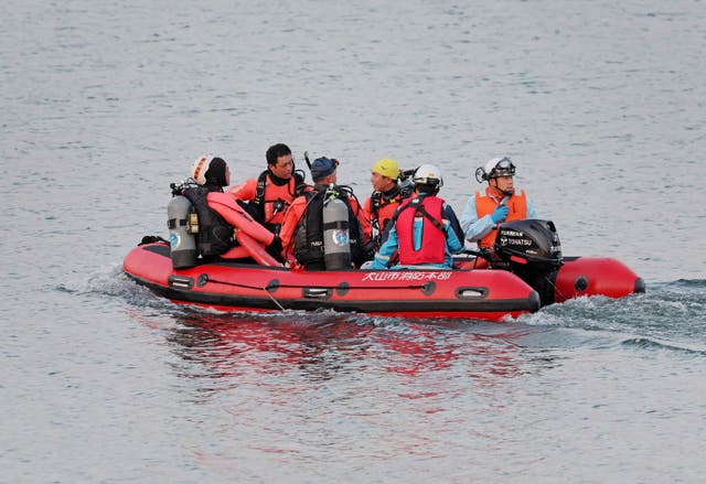 <p>Firefighters search the area where a Japan Air Self-Defense Force training plane T-4 crashed, at Lake Iruka in Inuyama City, Aichi Prefecture</p>