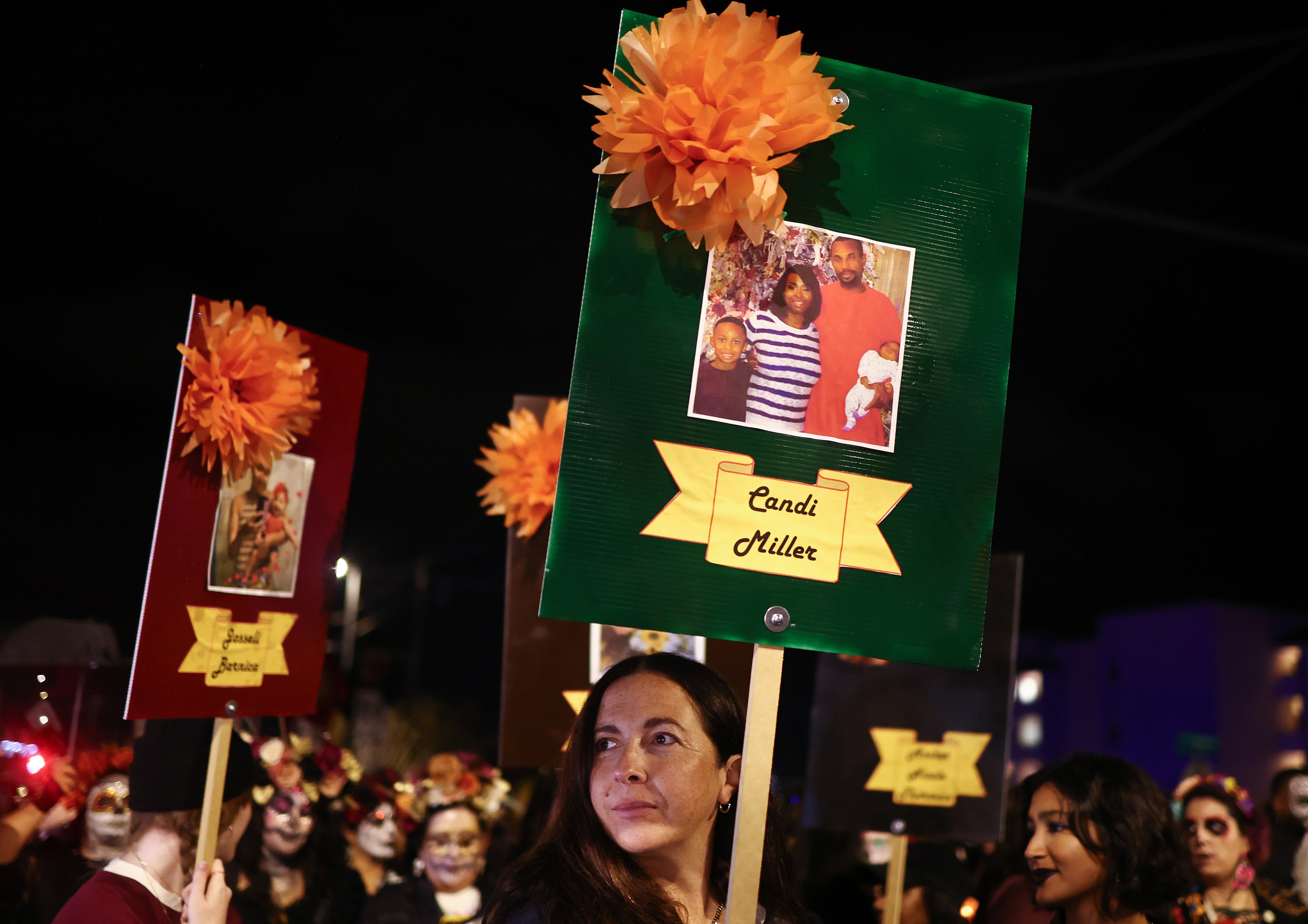 Activists in Arizona carry photographs of women who died because of abortion bans in Georgia and Texas