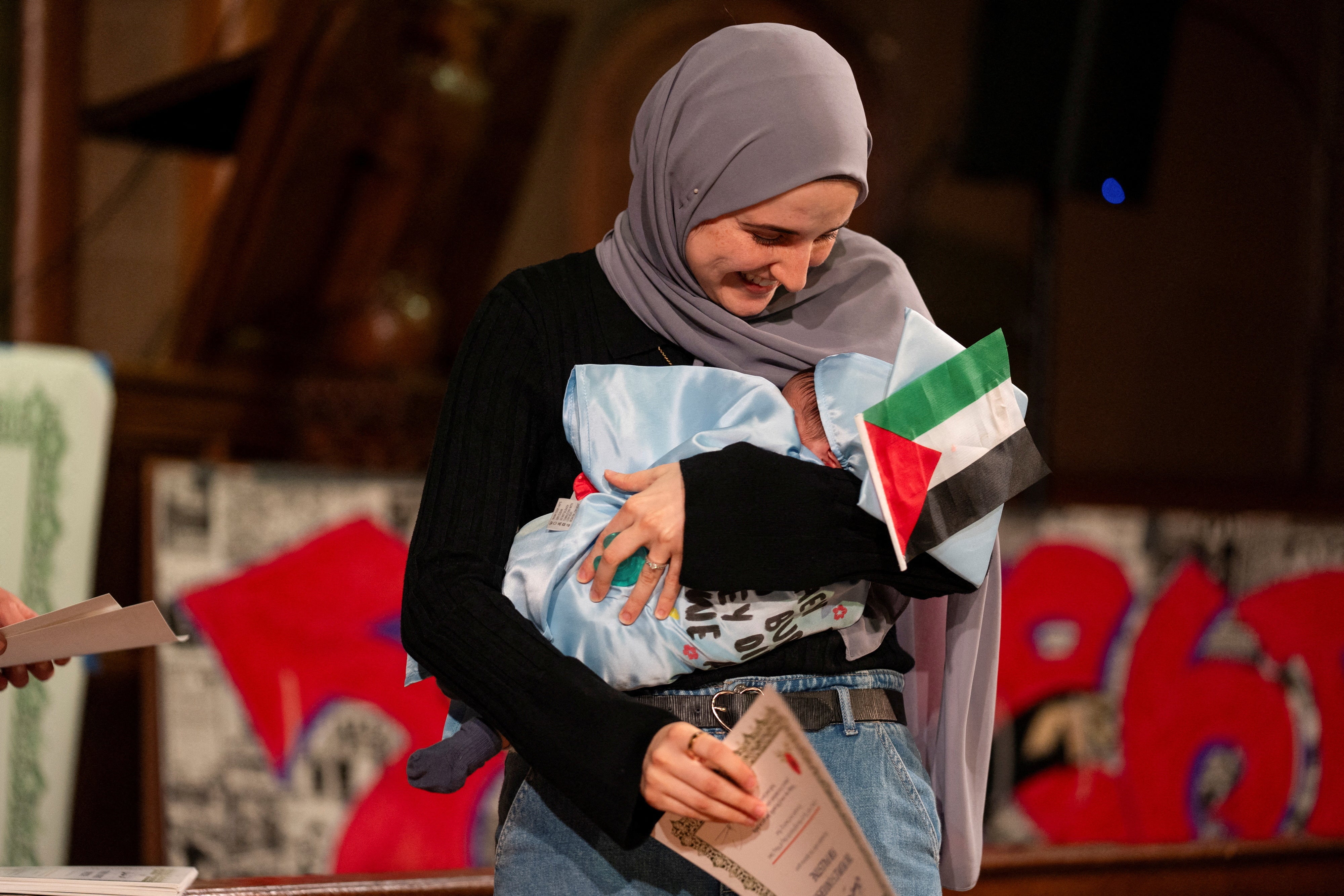 Mahmoud Khalil's wife Noor Abdalla, with their son, accepted an an honorary diploma for Khalil during an event from Columbia University students unable to participate in a commencement ceremony