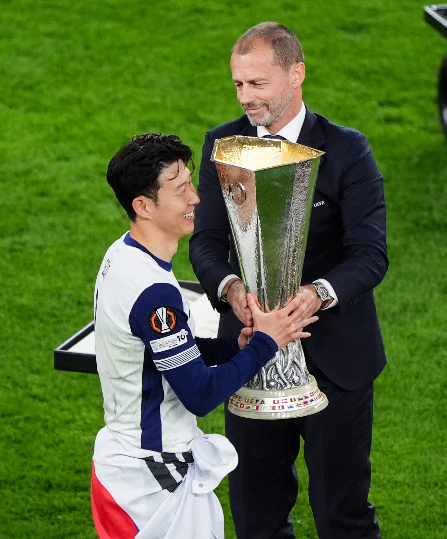 Tottenham Hotspur's Son Heung Min receives the Europa League trophy from Uefa president Aleksander Ceferin