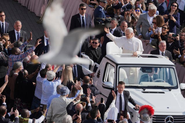 <p>A bird flies by as Pope Leo XIV on his popemobile tours St. Peter's Square at the Vatican prior to the inaugural Mass of his pontificate, Sunday, May 18, 2025. (AP Photo/Jacquelyn Martin, Pool)</p>